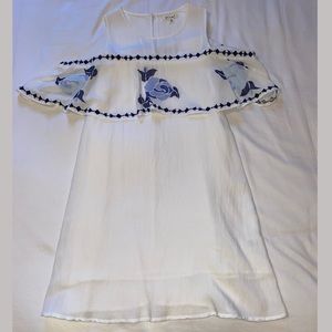 White dress with blue embroidery